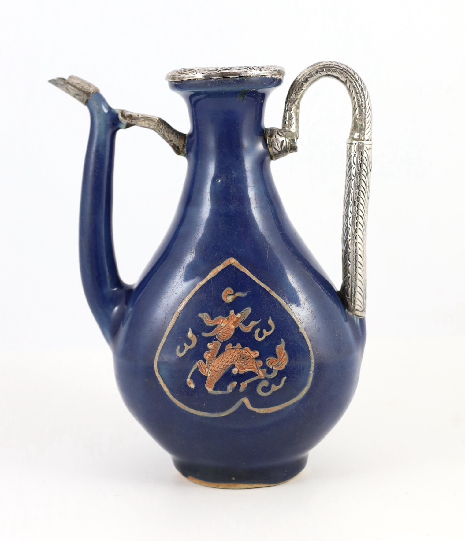 A Chinese late Ming blue glazed and slip decorated ‘qilin’ ewer, for the Islamic market, 20cm high, later Islamic silver mounts, wear